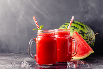 Fresh tasty delicious watermelon juice on a dark background