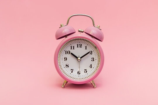 A certain time. An appointment has been made. Time to buy to buy gifts for children for the holidays. Happy time. Signature space, isolated pink background, studio photo.