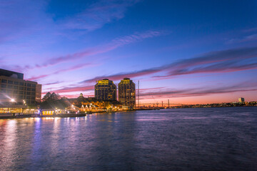 A dynamic night view of bustling Halifax Waterfront Harbor front with prominent business and...