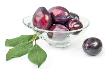 Group of plums with leaves isolated on a white background