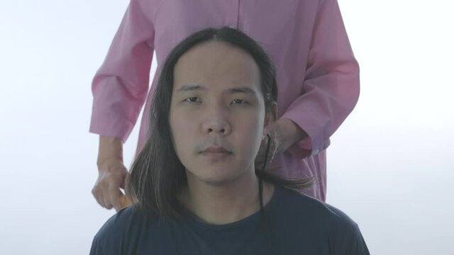 Hair care concept of 4k Resolution. Hairdresser is tying hair for customers.