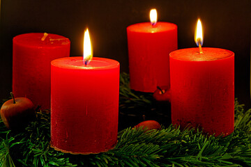 advent wreath with three burning candels for the third advent sunday