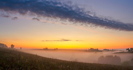 Foggy landscape at sunrise