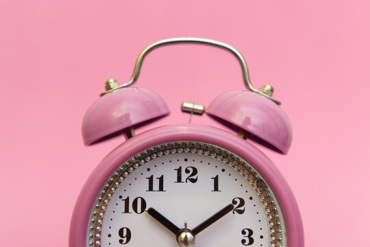 A Small Retro Pink Alarm Clock Looks At The Screen. It's Time To Stay Home And Stay Safe. Now Is The Time To Call Family And Friends. You Can't Put It Off. Deadlines Are Approaching.