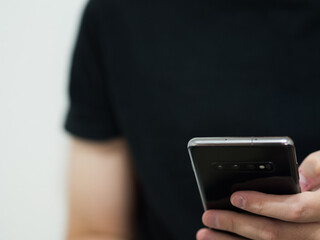Unrecognizable man watching the news from his smartphone