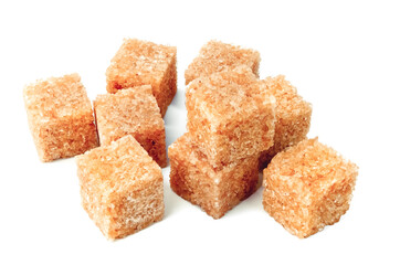Lump brown cane sugar cubes isolated on white background