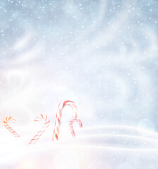 Christmas candy canes on snowy background.