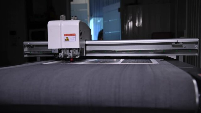 Close-up shallow depth of field a production plotter at a printing house automatically cuts packaging and labels from cardboard