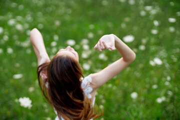 Obraz premium Woman in white dress in a field of flowers walk freedom