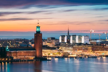 Foto op Canvas Stockholm, Sweden. Scenic Skyline View Of Famous Tower Of Stockholm City Hall And St. Clara Or Saint Klara Church. Popular Destination Scenic View In Sunset Twilight Dusk Lights. Evening Lighting © Grigory Bruev