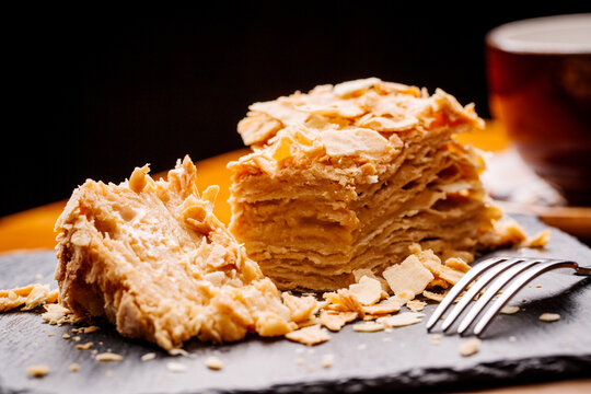 Napoleon cake on plate on table close-up. Homemade custard puff cake.