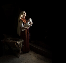Mary in the stable near the manger with the baby