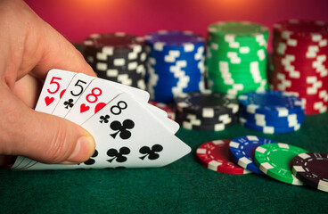 Poker cards with two pairs combination. Close up of gambler hand takes playing cards in poker club