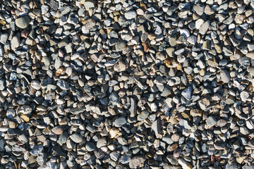 The texture of coarse gravel in full screen as a background.