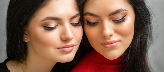 Fototapeta premium Portrait of young beautiful two women with long lashes and closed eyes after eyelash extensions