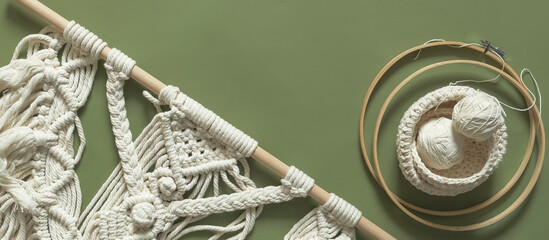 Macrame. Handmade macrame weaving and cotton threads on a rustic wooden stick. Scandinavian style...