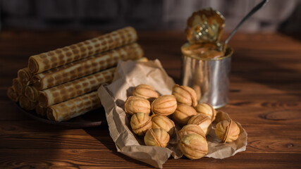 wafer rolls with condensed milk. cookies nuts with condensed milk. Food on a black background. Homemade baking. baking nuts.