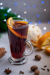 Mulled wine in a glass glass on a gray concrete background