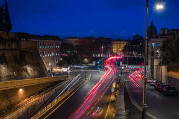 Fototapeta premium Cool long exposure bus traffic neon blue-orange light trails, night view on the street road, Rome, Italy 