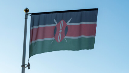 National flag of Kenya on a flagpole in front of blue sky with sun rays and lens flare. Diplomacy concept.