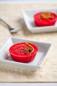 Authentic Filipino sweet rice cakes- Kutsinta. Close up delicious Cuchinta served in a modern white plate.