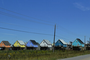 Fototapeta na wymiar Colorful houses on stilts, Surfside Beach, Galveston Island, Texas