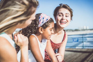 happy gay couple spending time together with their adopted daughter