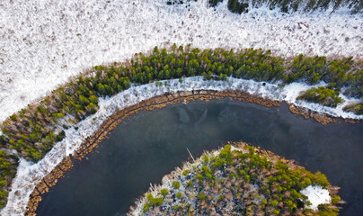 Aerial view of the blue river and green forest. Beautiful nature landscape in winter