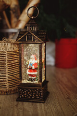Christmas lantern with decoration and snow flakes. retro lantern night light, with santa claus. snowflakes crystal globes. Interior design. winter holidays