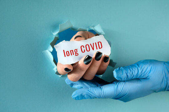 Long Covid, Post Covid Syndrome, Long Covid. Hand In Glove Supporting Hand With Text On Paper Scrap In Paper Hole. Covid Long Haulers, Long-term Effects Of Virus Infection In Patients. Helping Hand.