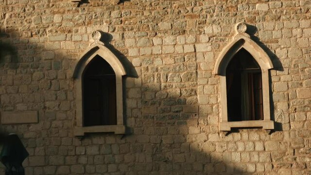 The view from the drone. Creative. A beautiful brick architectural building with green vegetation nearby and open dark windows
