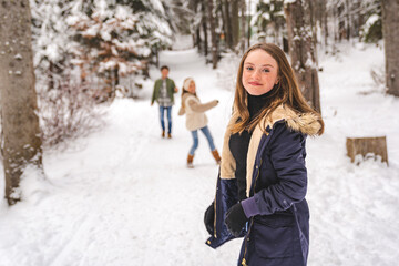 Fototapeta na wymiar cute Little girl in winter snow forest