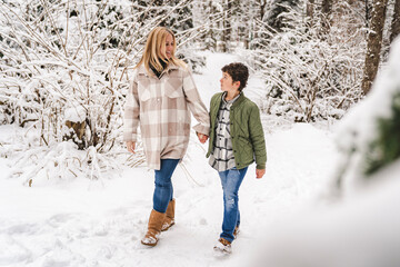 Fototapeta na wymiar boy and mother on forest in winter season