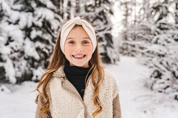 cute Little girl in winter snow forest