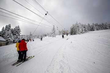 People who ski with a chairlift in the snowy mountains.   The concept of Christmas holidays. Mount Uludag Bursa Turkey