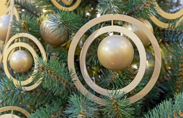Christmas ball of gold-colored with rings. New Year decorations in space style.