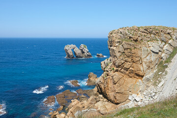 Fototapeta na wymiar Big rocks in the middle of the sea under a blue sky