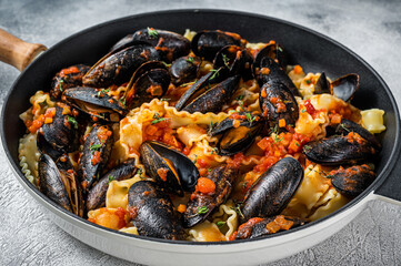Traditional italian seafood pasta with mussels, Spaghetti and tomato sauce. White background. Top view