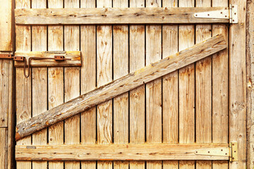 Wooden door to the barn or horse stall, lock on the door.