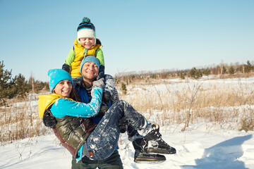 happy playing family in the winter. people outdoors
