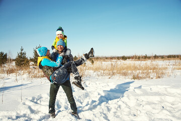 happy playing family in the winter. people outdoors - 472500601