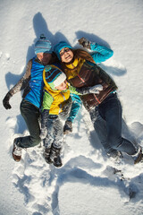 happy playing family in the winter. people outdoors - 472500609