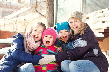 portrait of a family near a house in the winter outdoors - 472500612
