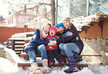 portrait of a family near a house in the winter outdoors - 472500613