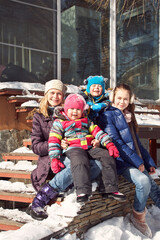 portrait of a family near a house in the winter outdoors