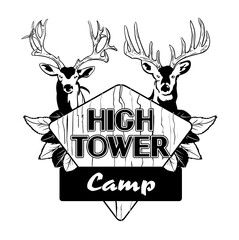 Two bucks standing behind leafy wooden sign