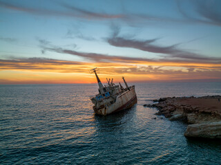 Fototapeta premium Cyprus - Abandoned shipwreck EDRO III in Pegeia, Paphos, Cyprus from drone view at amazing sunset time