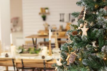 Christmas tree with natural woods decorating at home interior.