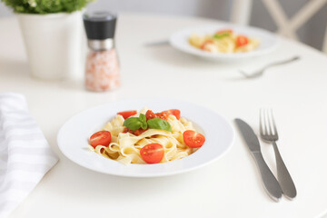 Fresh Italian pasta with cherry tomatoes, cheese and basil. Vegetarian spaghetti. Healthy food.