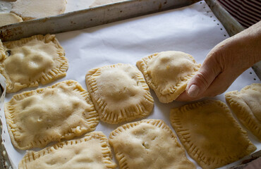 dough and flour on the table. cooking gingerbread. knead the dough to make a pie. grandmother prepares a cupcake. mom makes sweets.